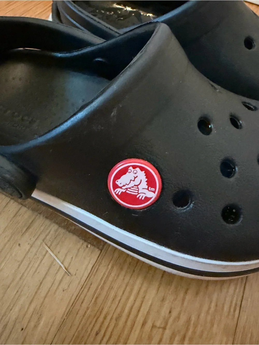 Kid’s black Croc slip on shoe with white band size 8